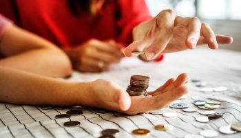 Male and female hands counting coins