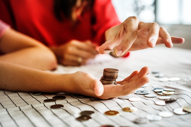 Male and female hands counting coins