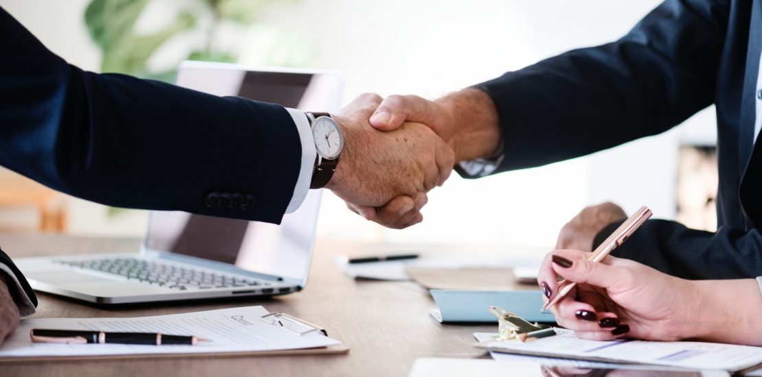 two businessmen arm handshaking