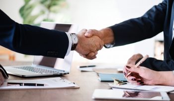 two businessmen arm handshaking