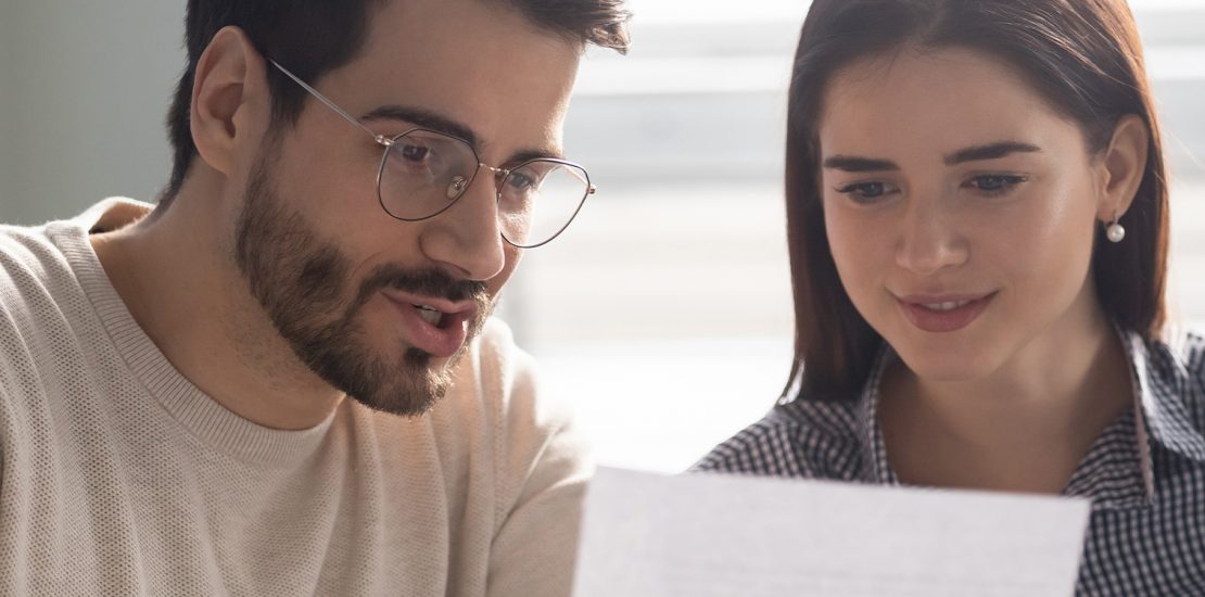 couple refinancing in front of a computer