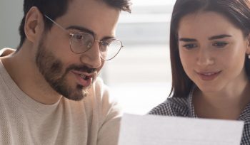 couple refinancing in front of a computer