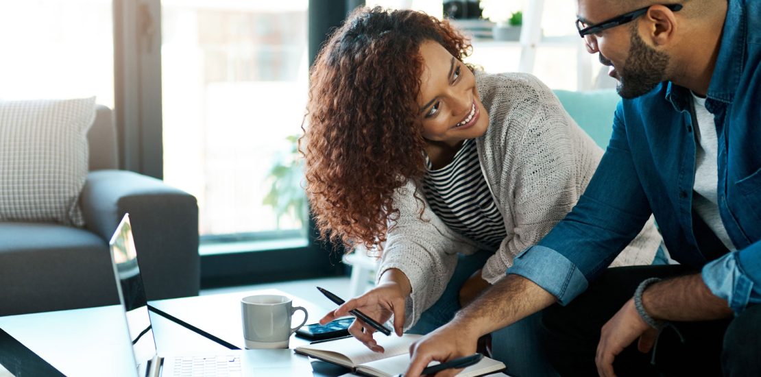 Couple doing accounting in living room table