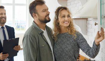 Couple visiting a new house with real estate manager