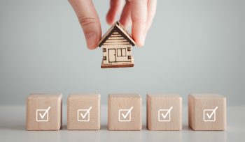 Hand holding a miniature house