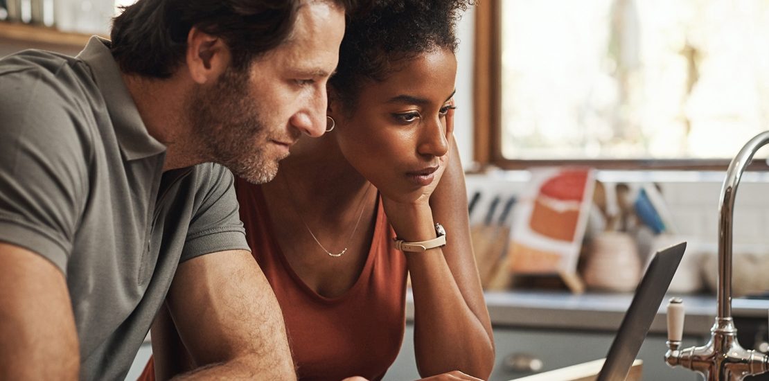 Man and woman working on accounting in a kitchen