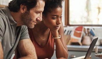 Man and woman working on accounting in a kitchen