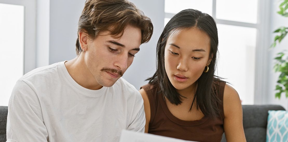 couple discussing home purchases on a couch