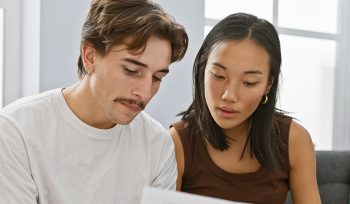 couple discussing home purchases on a couch