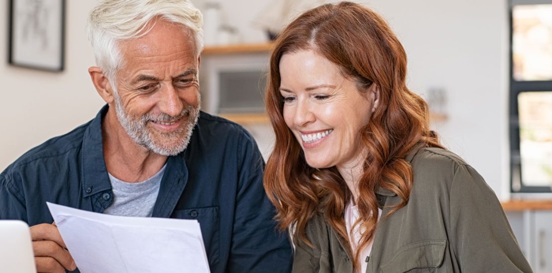 Family discussing finance in front of laptop