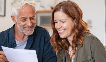 Family discussing finance in front of laptop