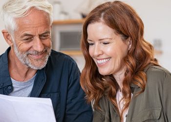 Family discussing finance in front of laptop