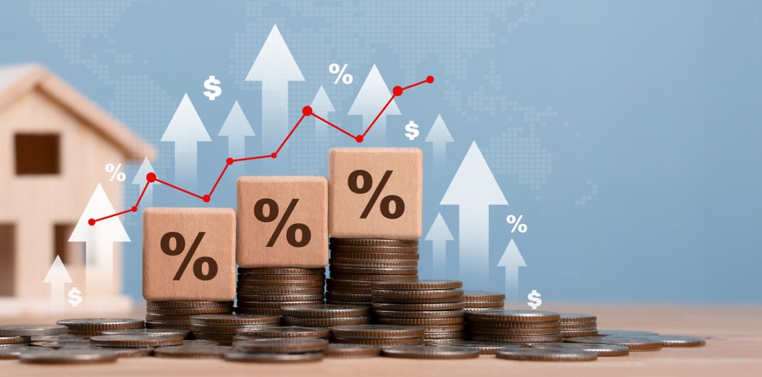 Miniature house and dices with interest rates